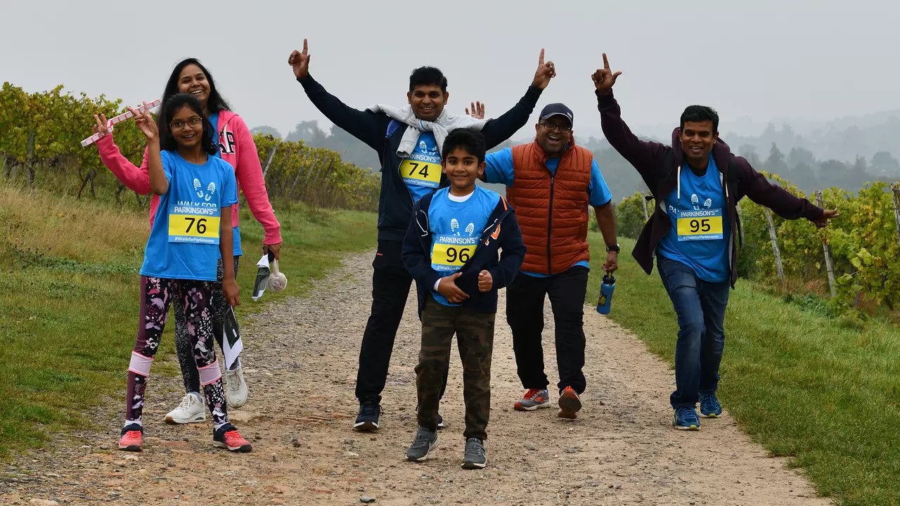 Walkers at Walk for Parkinson's 2021 Surrey Hills wave as they complete their walk