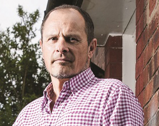 Matt Eagles, who has Parkinson's, standing outside his home.