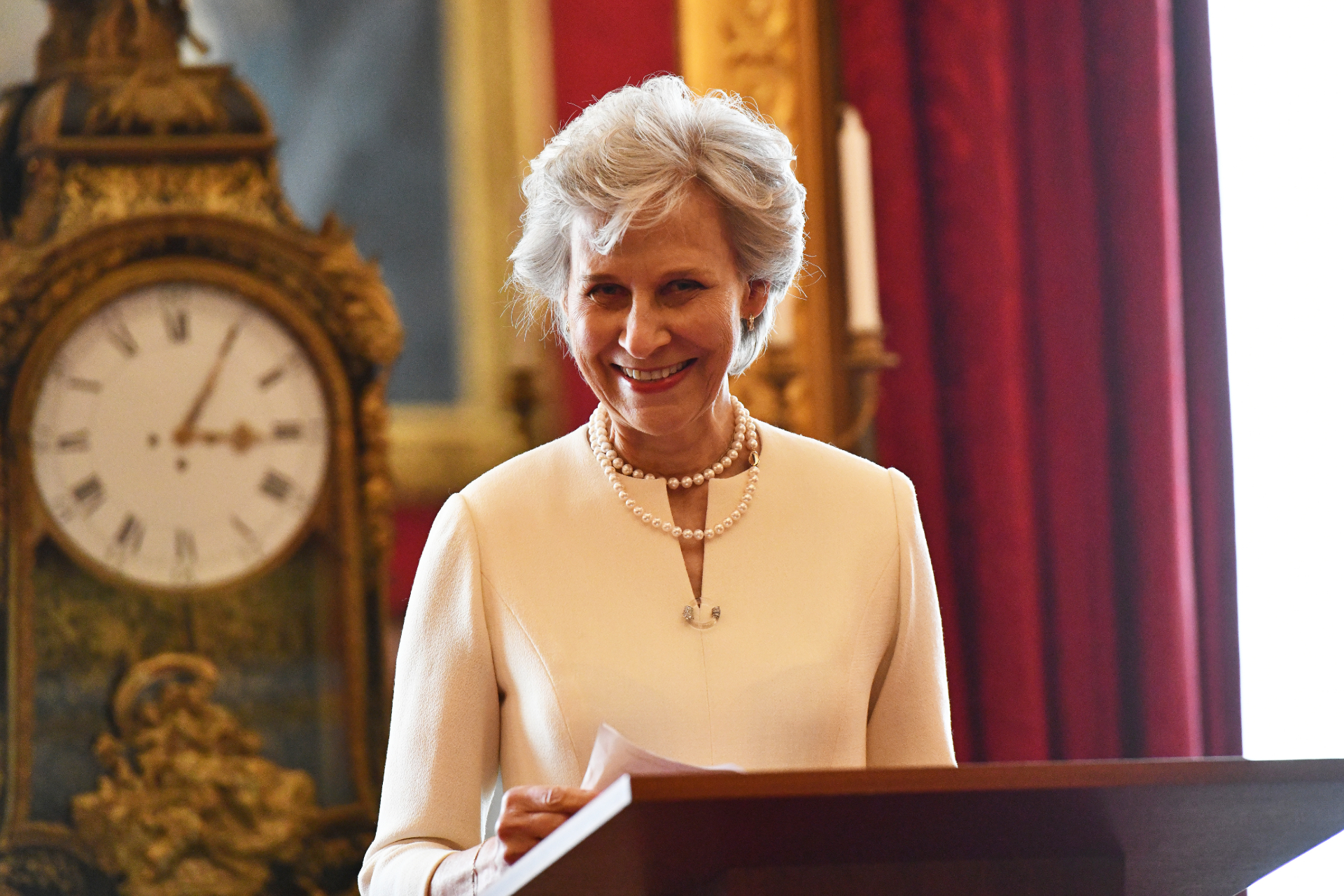 The Duchess of Gloucester smiling at a lectern