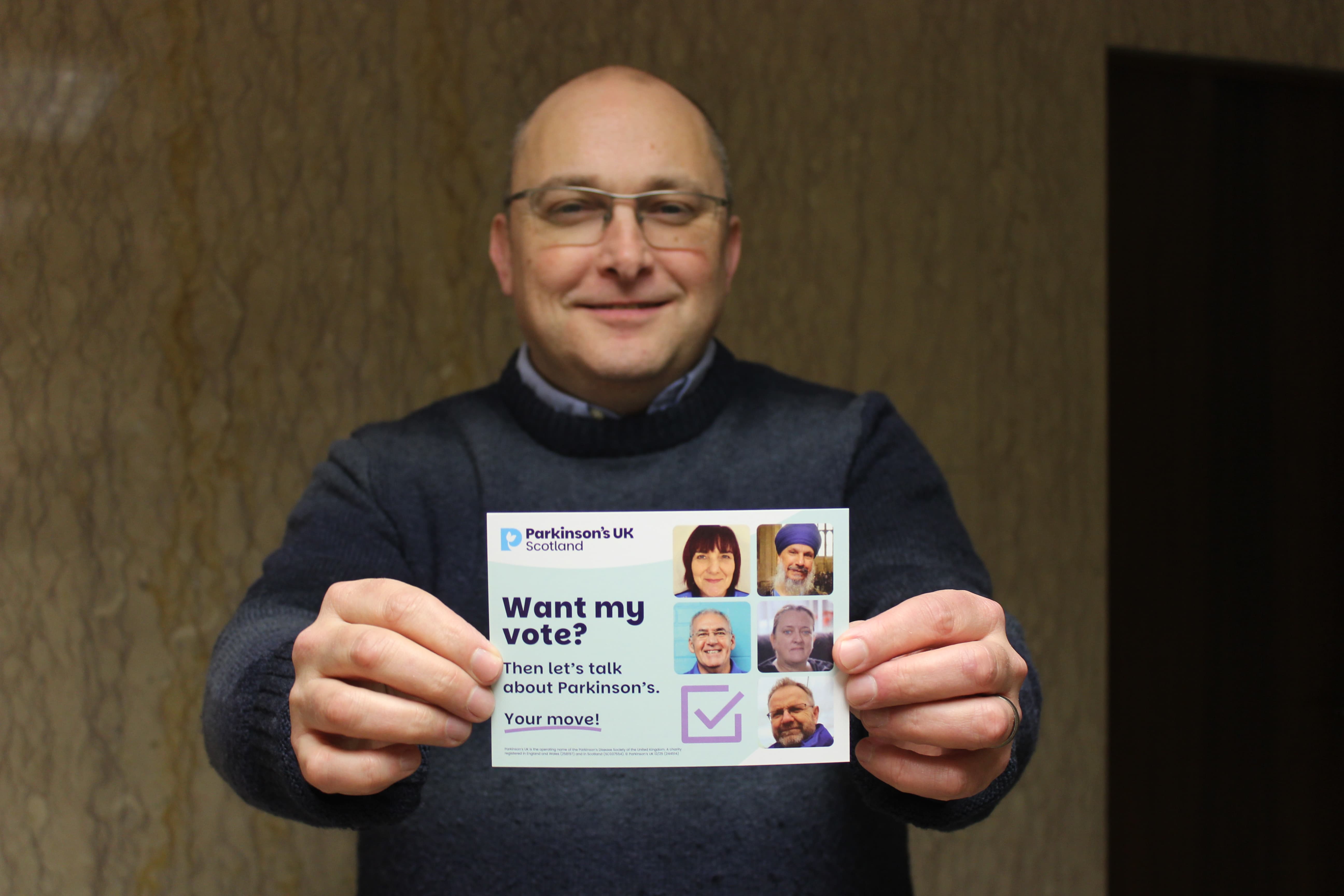 David Goldthorp holding up election postcard for Scottish Parliament election 2026