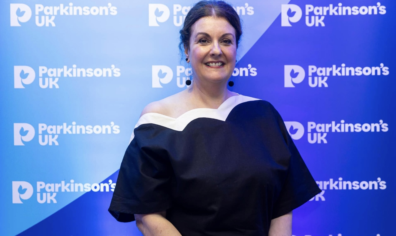 Claire Lindley, Parkinson’s Clinical Nurse Specialist, smiling at a Parkinson’s UK awards ceremony in a glamorous outfit.