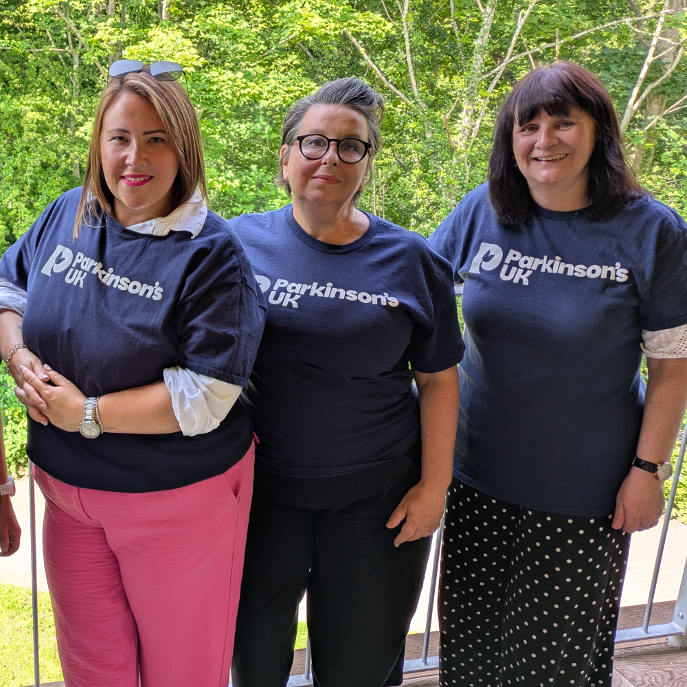 Our Community Development team in Wales standing in a line wearing Parkinson's UK navy t-shirts.  