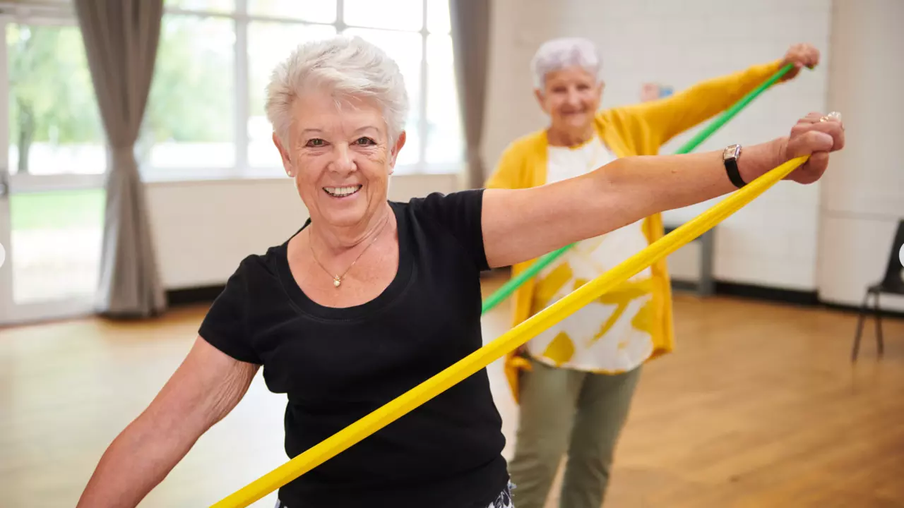 Smiling woman doing resistance band exercises
