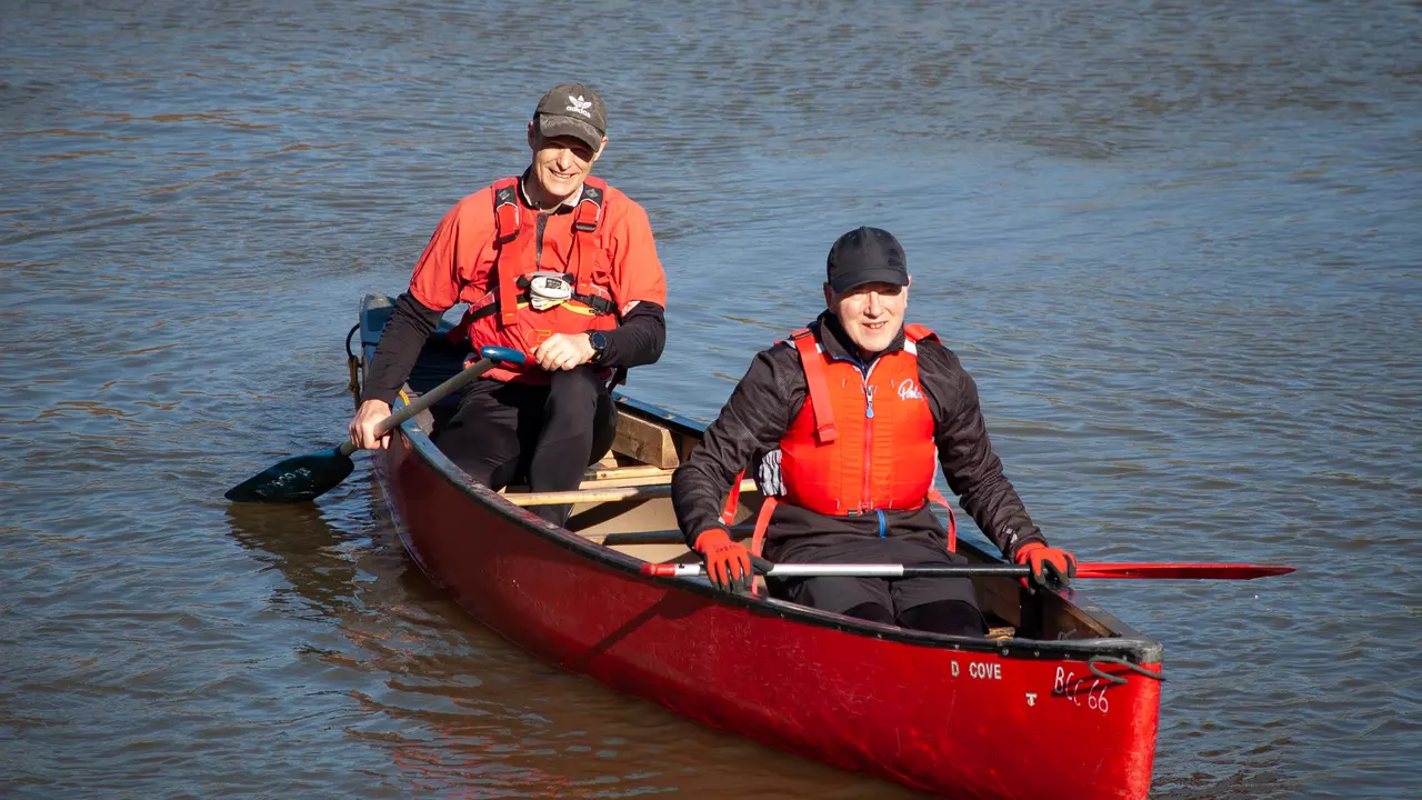 Two men paddling in a canoe