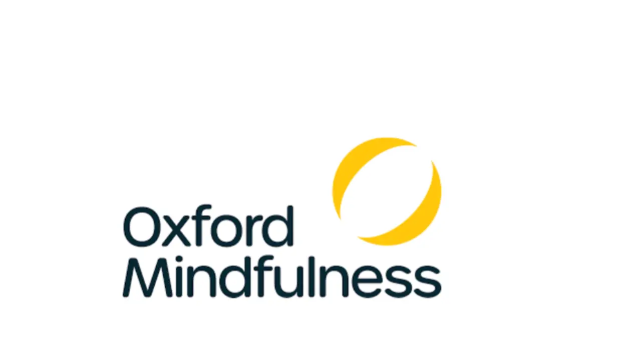 An image of the Oxford Mindfulness logo with a white background and blue text with a yellow logo