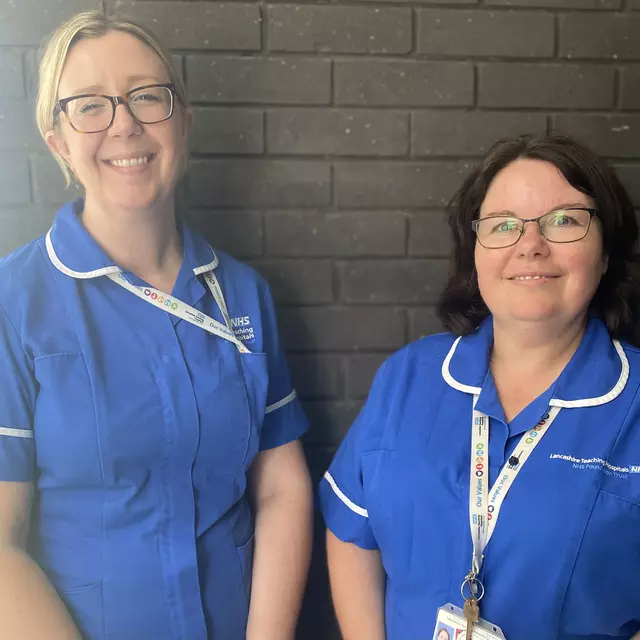 Jennifer and Nicola in blue nursing uniform, smiling to camera
