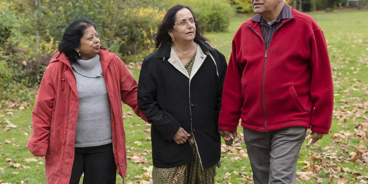 Alka, who has Parkinson's, walking with her family