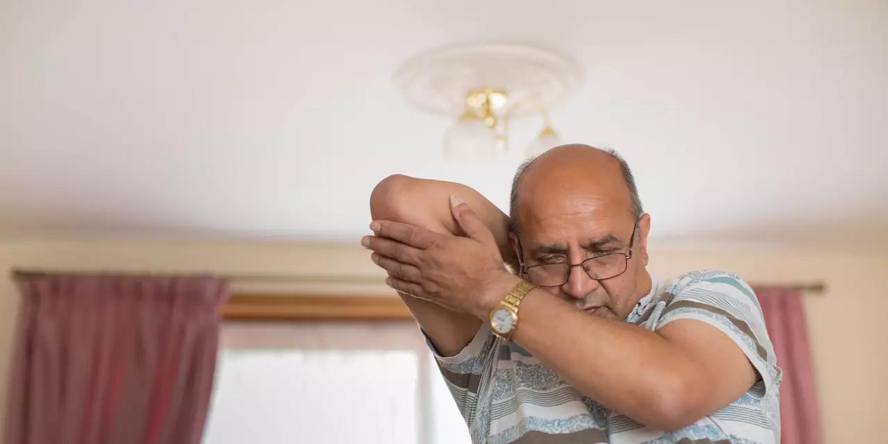 Man doing arm stretches at home
