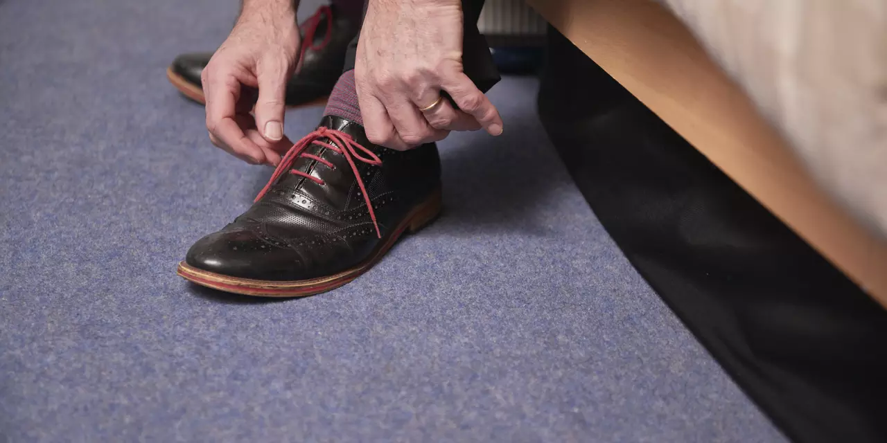 hand tying shoe laces