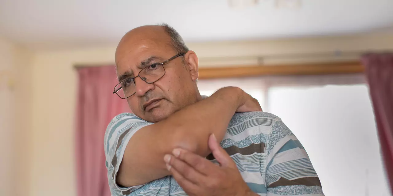 Person with Parkinson's stretching at home