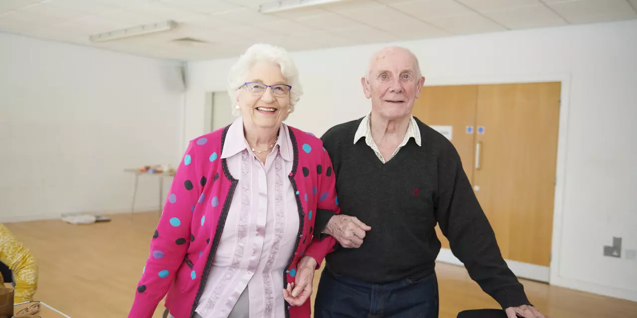 Man and woman with arms linked