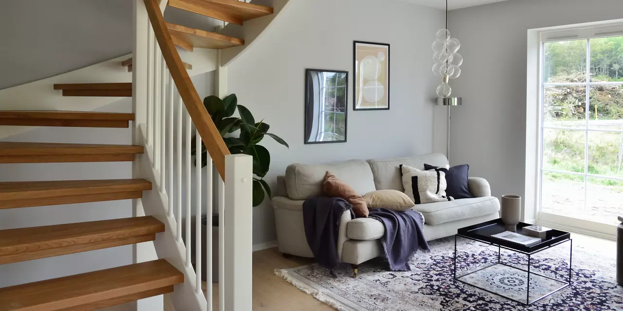 Living room with stairs to the left of the image