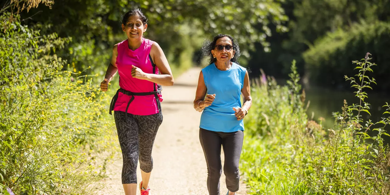 Two women on a run through a nice leafy setting
