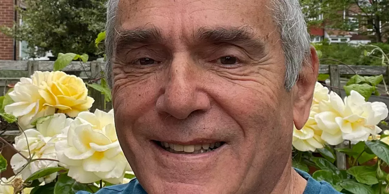 Ron Bernstein with flowers behind him