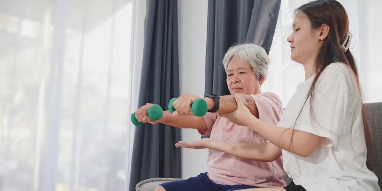 An older white woman exercising with dumbbells with the help of another woman. 