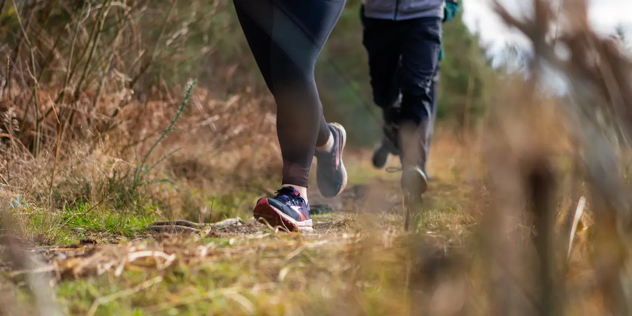Images of people running in woodland - image only shows their legs. 