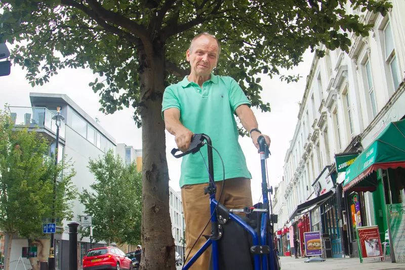 Bob, who has dyskinesia, with his walking aid.