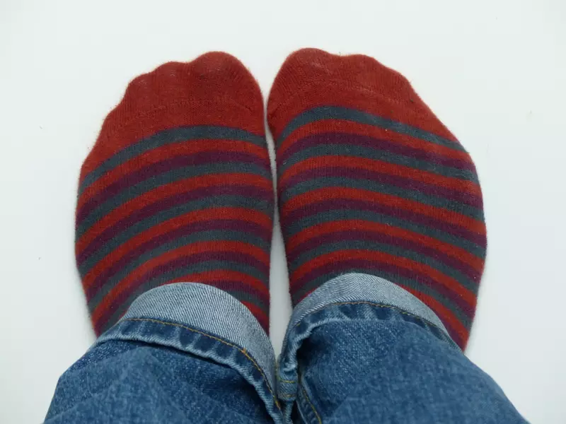 Person's feet wearing red stripy socks