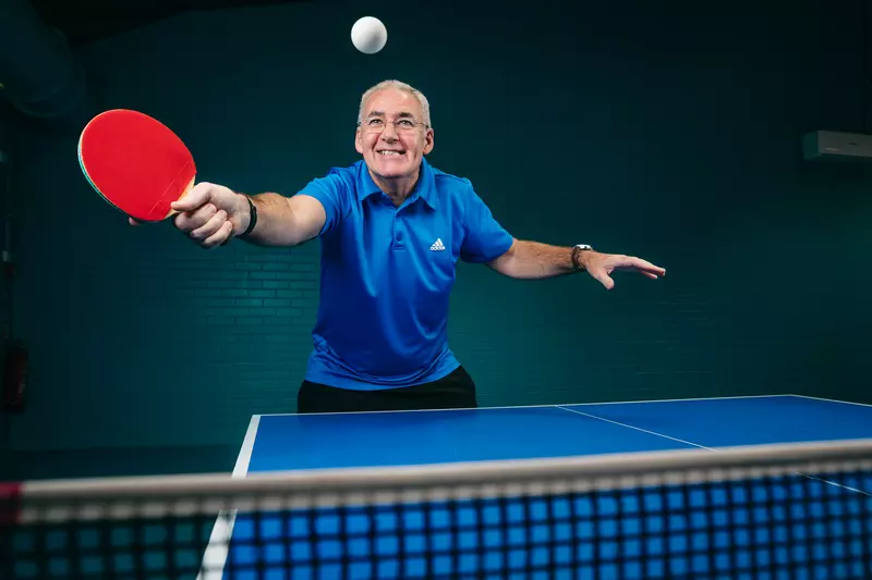Brian Carson hits a shot during a Table Tennis class
