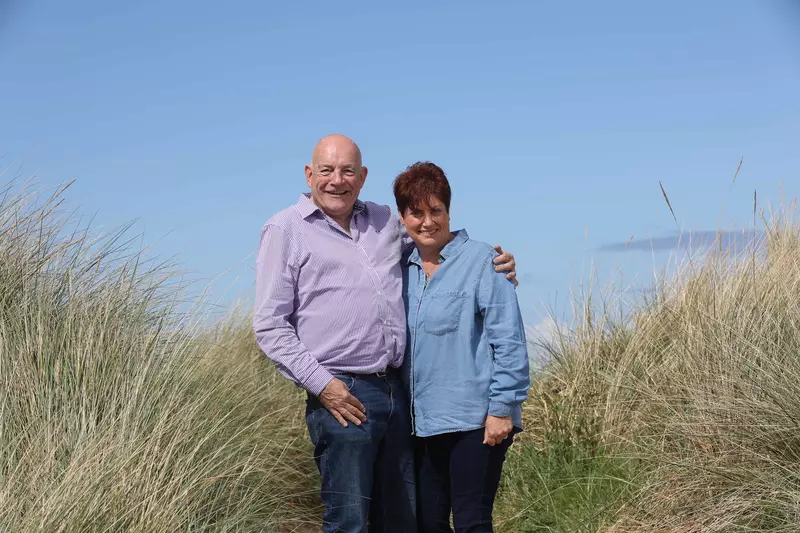 David is stood with his arm around Elaine.