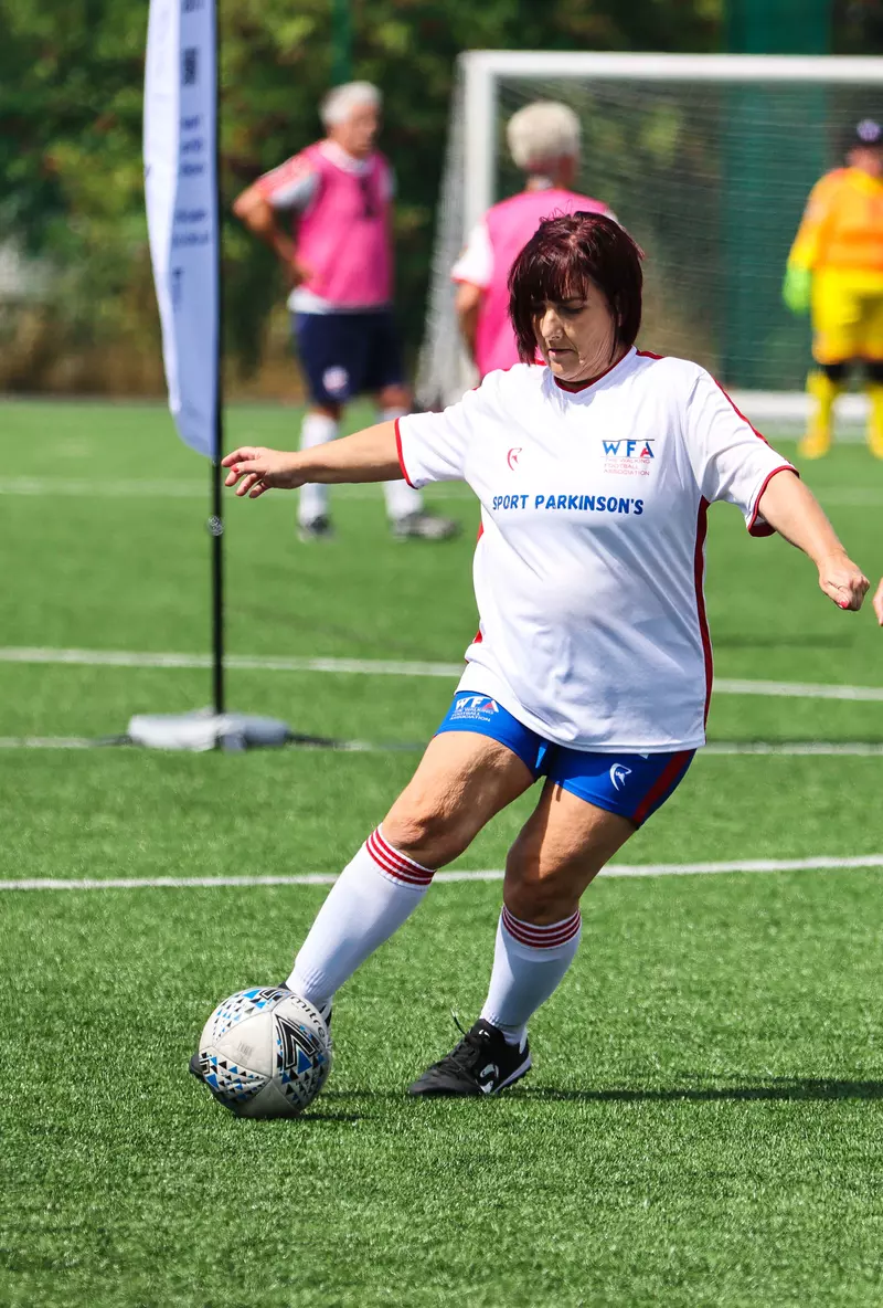 Annie dribbling a football.