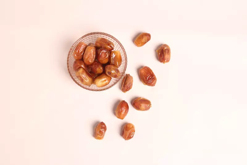 A bowl of dates that have been scattered.